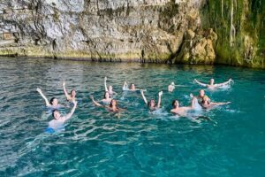 Blue Cave & Grama Bay Full Day Guided Boat Tour - Dafina Bay and Dafina Cave: beach swimming with mountains all around