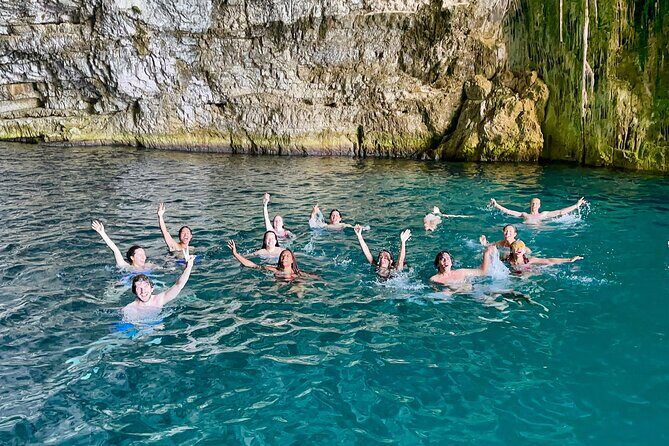Blue Cave & Grama Bay Full Day Guided Boat Tour - Dafina Bay and Dafina Cave: beach swimming with mountains all around